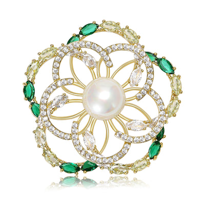 Front view of round floral brooch with green crystal border and pearl center against a white background.