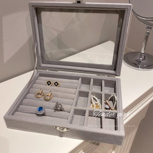 Front view of gray glass top compartment jewelry storage box for jewelry display