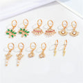 Gold Tone Huggie Earrings with Six Small Symbolic Drop Charms view 4