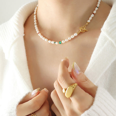 Model wearing pearl necklace green beads gold toggle clasp