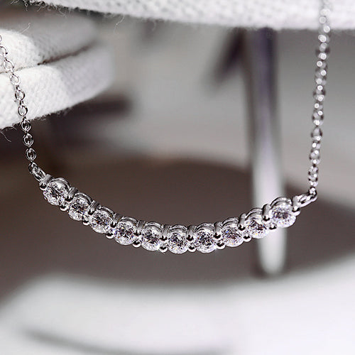 Side angle of smile bar necklace stones on silver chain