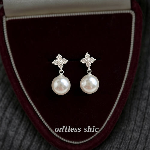 Silver-tone clear-stone-four-petal pearl studs in the first product display.