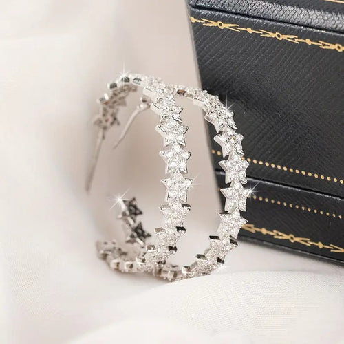 Silver Tone Star Stone Large Hoop Earrings with Clear Stone Accents shown in styled view