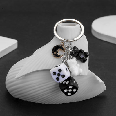 Overview showing the available color and design variations of the black white dice bear and moon resin metal keychain