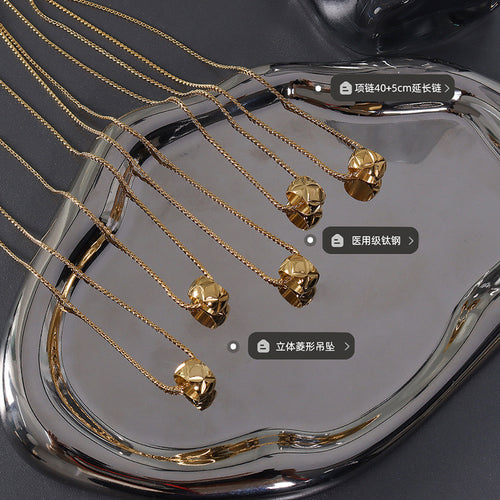 Multiple gold diamond bead pendants in tray with size material labels