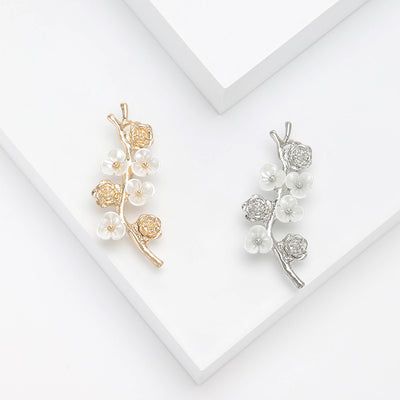 Delicate Branch Brooch With Clear Flowers and Pearls shown from the front on a white background