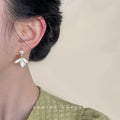 Gold Tone White Pearl Top And Three Petal Flower Drop Stud Earrings view 2