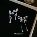 Crystal Bow Tassel Earrings with Asymmetric Silver Tone Drops view 2