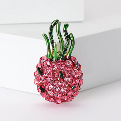 Front view of a pink crystal fruit with striped green leaves
