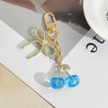 Resin Cherry Pair Charm Keychain with Gold Tone Hardware Accents view 7