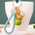 Coin and Persimmon Charm Keychains with Braided Wrist Loops view 3
