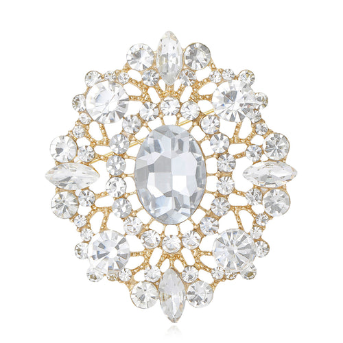 Display view of large oval court crystal brooch standing on white blocks.