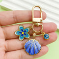 Starfish, Conch and Shell Charm Keychains Featuring Navy Flower Across 64 Variations view 3