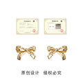 Gold Tone Sculpted Bow Stud Earrings With Stitched Ribbon Detail view 3