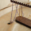 Purple Faceted Bead Necklace Black Square Gold Frame Pendant view 3