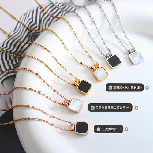 Six shell and black acrylic square pendants flat lay with labels