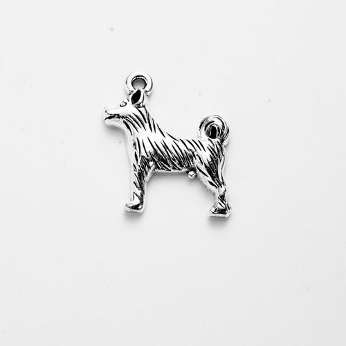Isolated standing dog charm component on a plain background