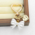 Gold Heart Clasp Charm Keychain With Bow Cherry Accent view 12