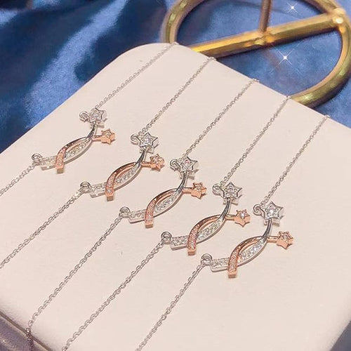 angled close-up of two-tone necklace with linked silver and rose gold-tone stars