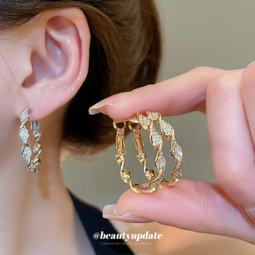 Gold Tone Twisted Hoop Earrings With Leaf Shaped Links