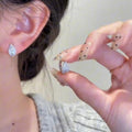 White Gold Tone Pave Crystal Leaf Huggie Hoop Earrings view 2