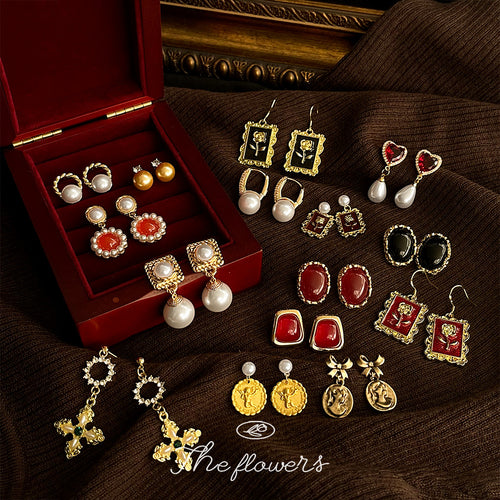 Jewelry box scene with many vintage gold pearl earring styles