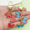 Three Bow Charm Keychain in Red or Blue with Gold Tone Clasp view 2