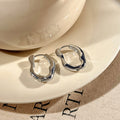 Irregular Sculpted Metal Hoop Earrings in Gold and Silver view 6