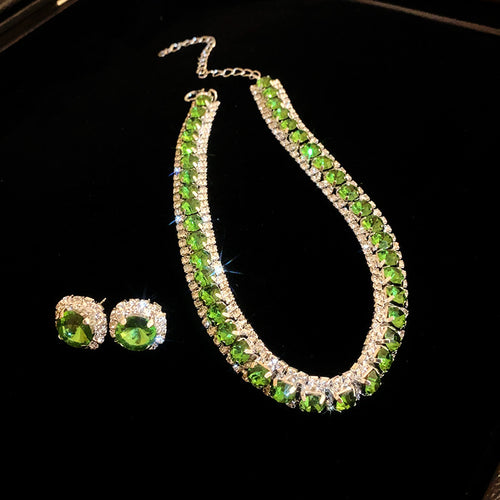 sixteen crystal necklace and stud earring sets with round or teardrop stones in varied colors shown in gallery image 2