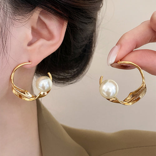 Gold Tone Curved Leaf Hoop Earrings with Pearls shown in a styled or display view