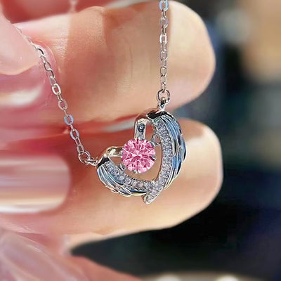 Product view showing an open silver-tone heart wrapped by crystal-set wings