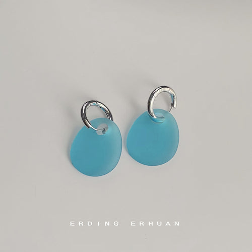 Silver mini huggie and frosted aqua acrylic drops on white