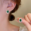 Green Oval Crystal Stud Earrings with Silver Tone Border view 1