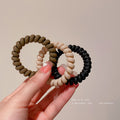 Black Matte Telephone Cord Spiral Coil Hair Tie With Thick Profile view 4