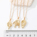 Gold Tone Sculpted Hand, Foot and Ear Pendant Necklaces view 5