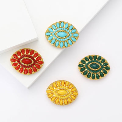 Four gold oval cabochon brooches in red turquoise green and yellow