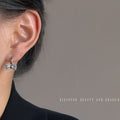 Pavé CZ Bow Huggie Hoop Earrings Gold and Silver Tones view 2