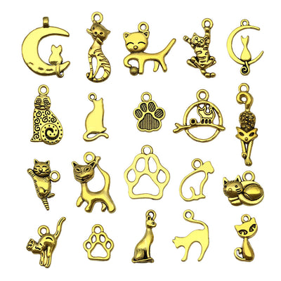 Matte gold-tone assorted shape charms arranged on a light background