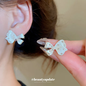 Silver Tone Crystal Bow Stud Earrings with Openwork Details