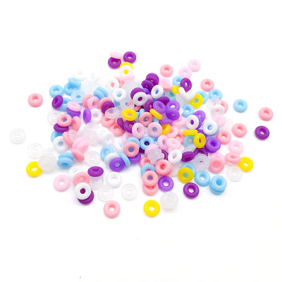 Assorted crimp bead jewelry findings arranged on a light background