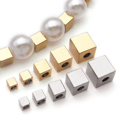 Gold-tone spacer bead beads arranged on a light background