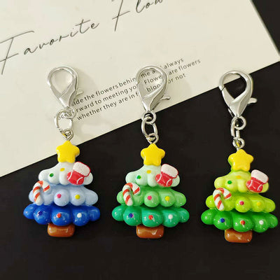Three resin Christmas tree keychains yellow-green teal and white-blue
