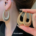 Textured and Polished Oval Hoop Earrings in Gold and Silver view 2