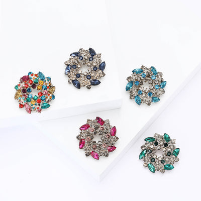 Front view of round floral wreath built from marquise and round faceted stones