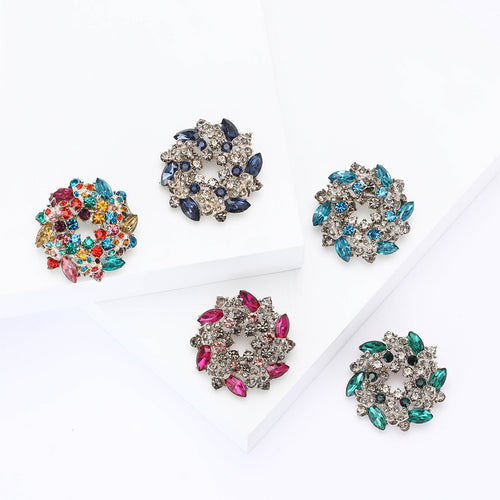 Front view of round floral wreath built from marquise and round faceted stones