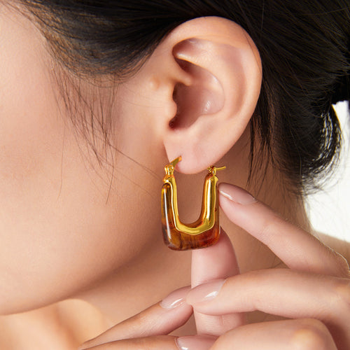 Model wearing gold amber resin U-shape hoop earring