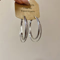 Polished Double Hoop Earrings In Gold And Three Silver Sizes view 8