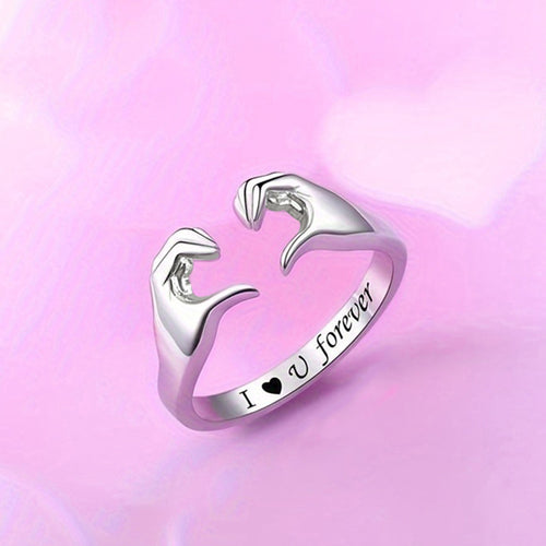 Silver heart gesture open ring on soft pink heart background