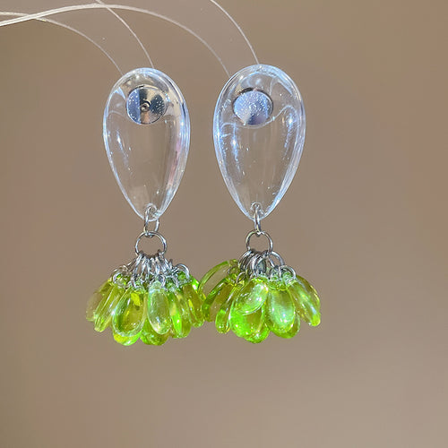 Transparent teardrops finished with clustered faceted crystal beads displayed in a close product arrangement.