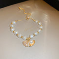Gold Tone Irregular Pearl Like Slider Bracelet With Shell Charm view 6